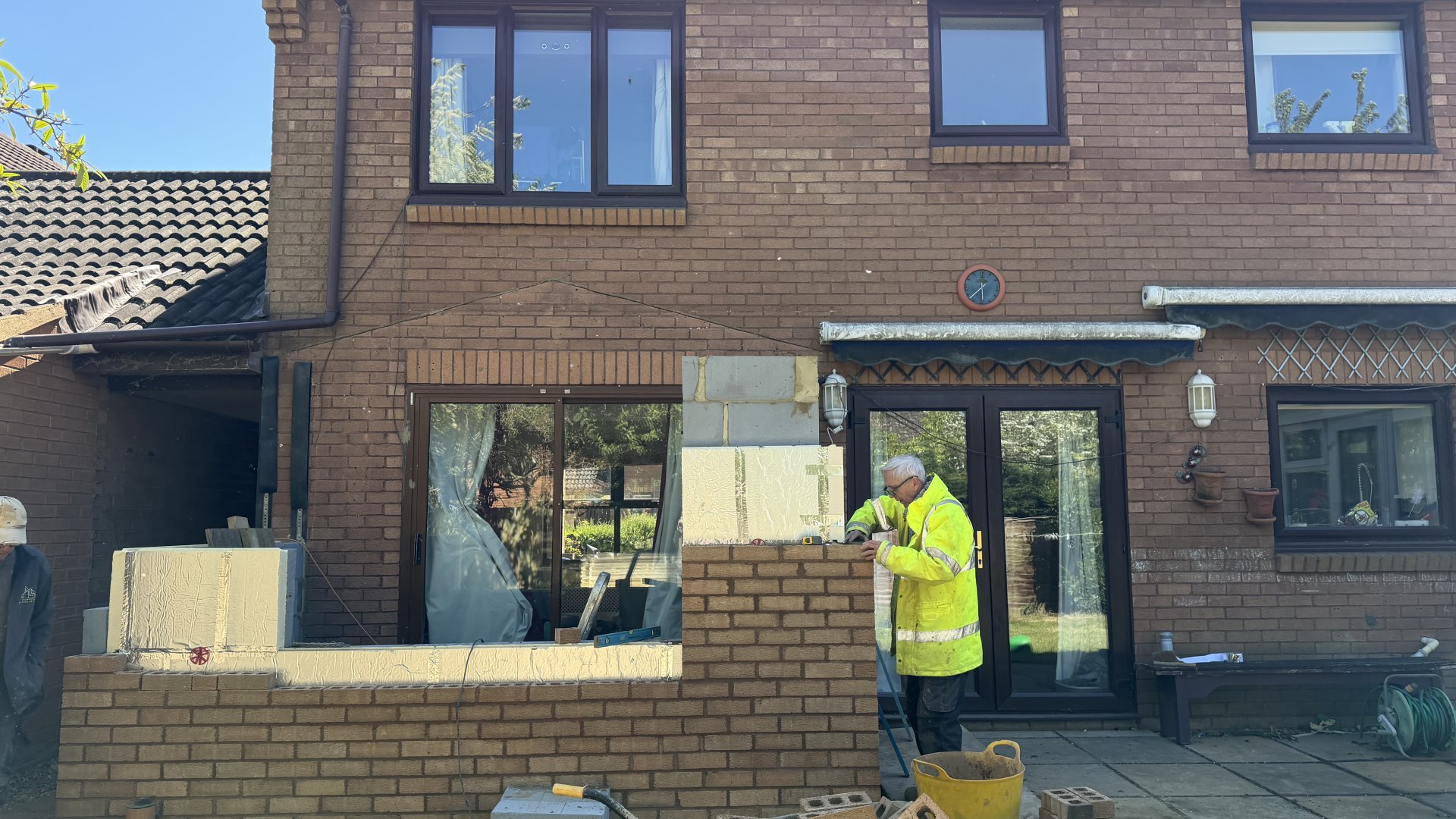 Homeowner reviewing home extension plans with builder in Milton Keynes — PMJ Building Services consultation